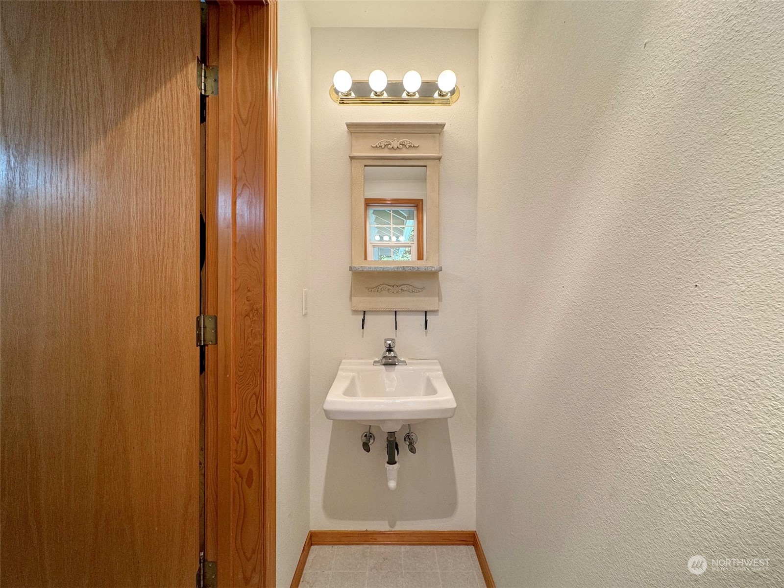 110 Henkes Road Sequim, WA 98382 - Photo 15 of 40 a bathroom with a sink a mirror and a window