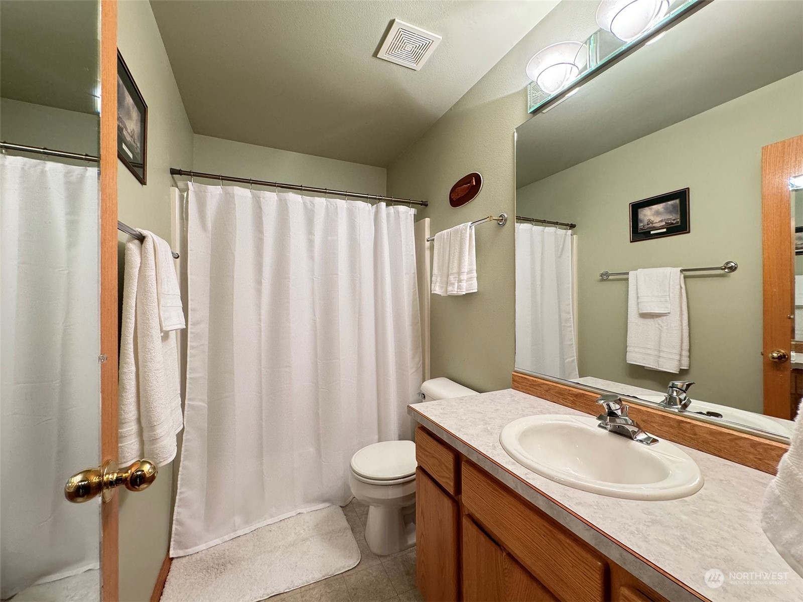 110 Henkes Road Sequim, WA 98382 - Photo 19 of 40 a bathroom with a granite countertop sink toilet and shower