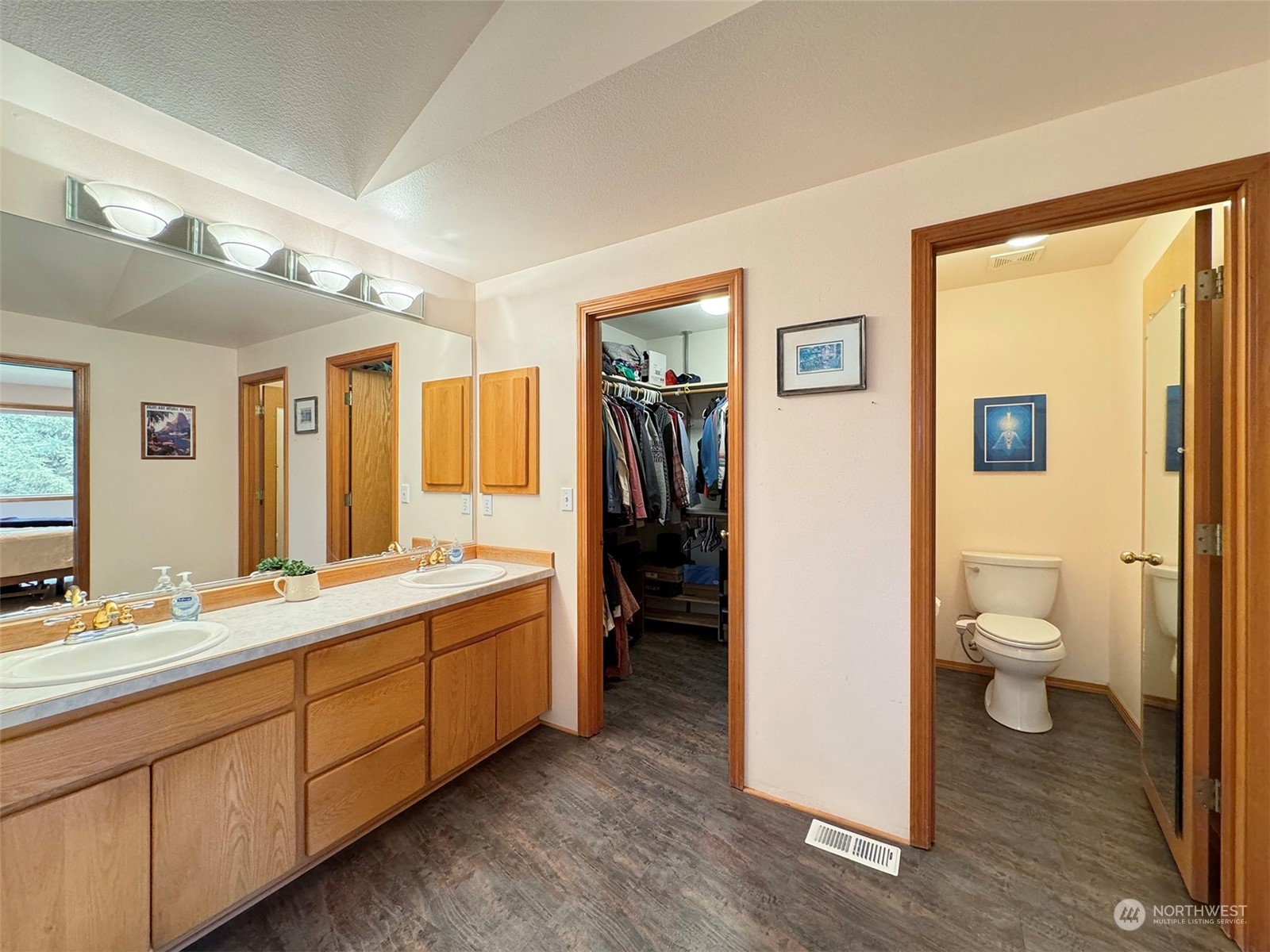 110 Henkes Road Sequim, WA 98382 - Photo 23 of 40 a spacious bathroom with a double vanity sink a large mirror and a toilet