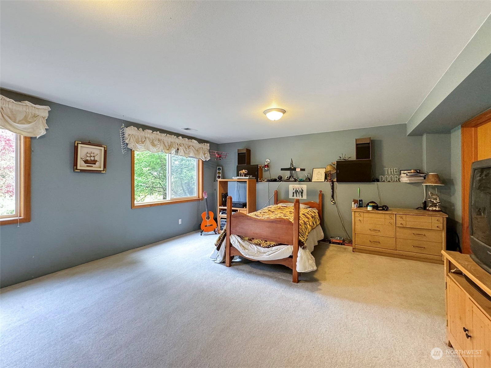 110 Henkes Road Sequim, WA 98382 - Photo 27 of 40 a bed room with furniture and a flat screen tv