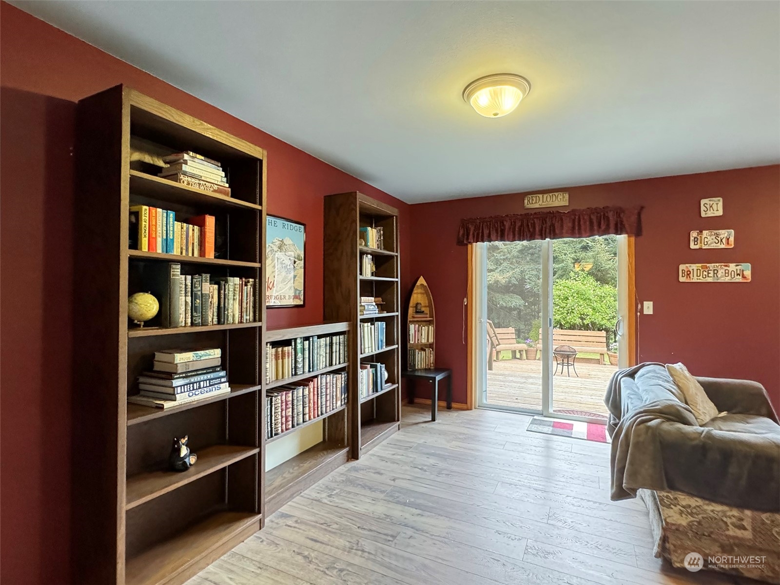 110 Henkes Road Sequim, WA 98382 - Photo 31 of 40 a living room with furniture a bookshelf and a window