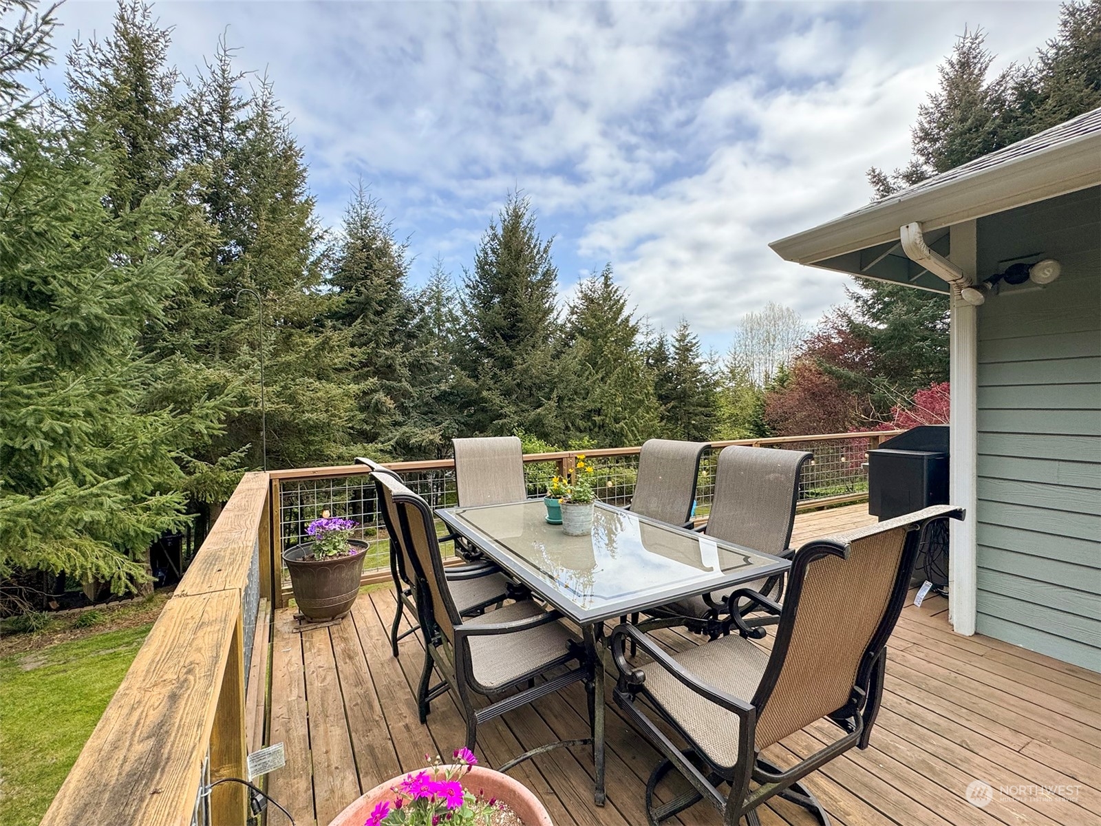 110 Henkes Road Sequim, WA 98382 - Photo 35 of 40 a roof deck with table and chairs and wooden floor