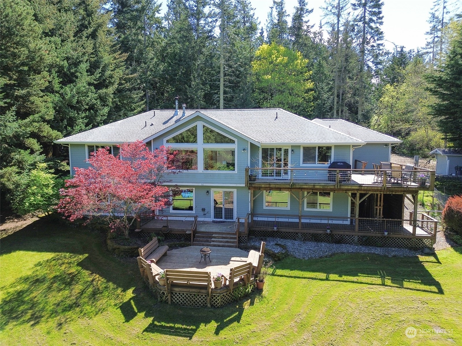 110 Henkes Road Sequim, WA 98382 - Photo 40 of 40 a front view of a house with swimming pool and a yard with furniture