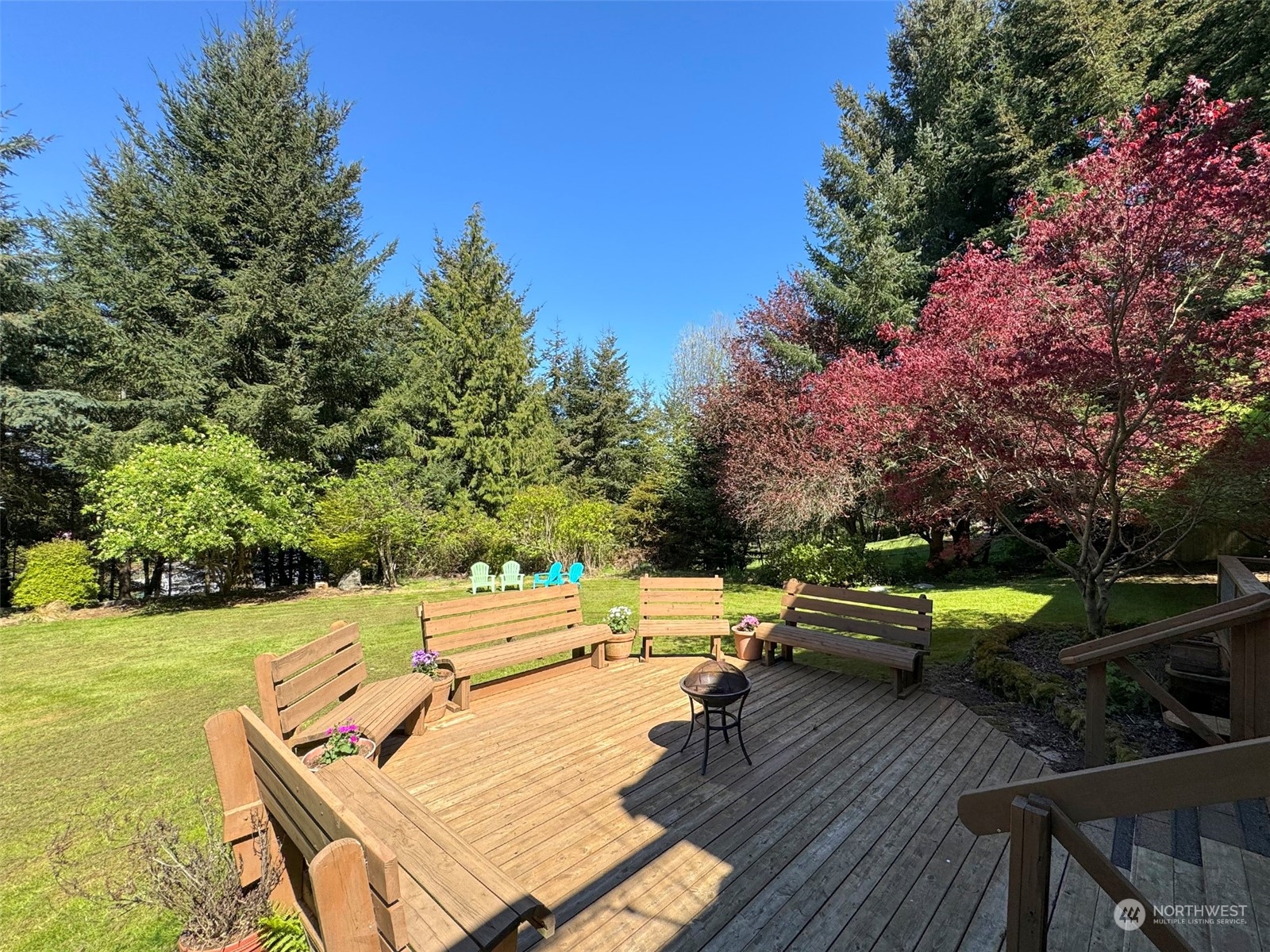 110 Henkes Road Sequim, WA 98382 - Photo 4 of 40 a view of a patio with table and chairs with wooden floor and fence