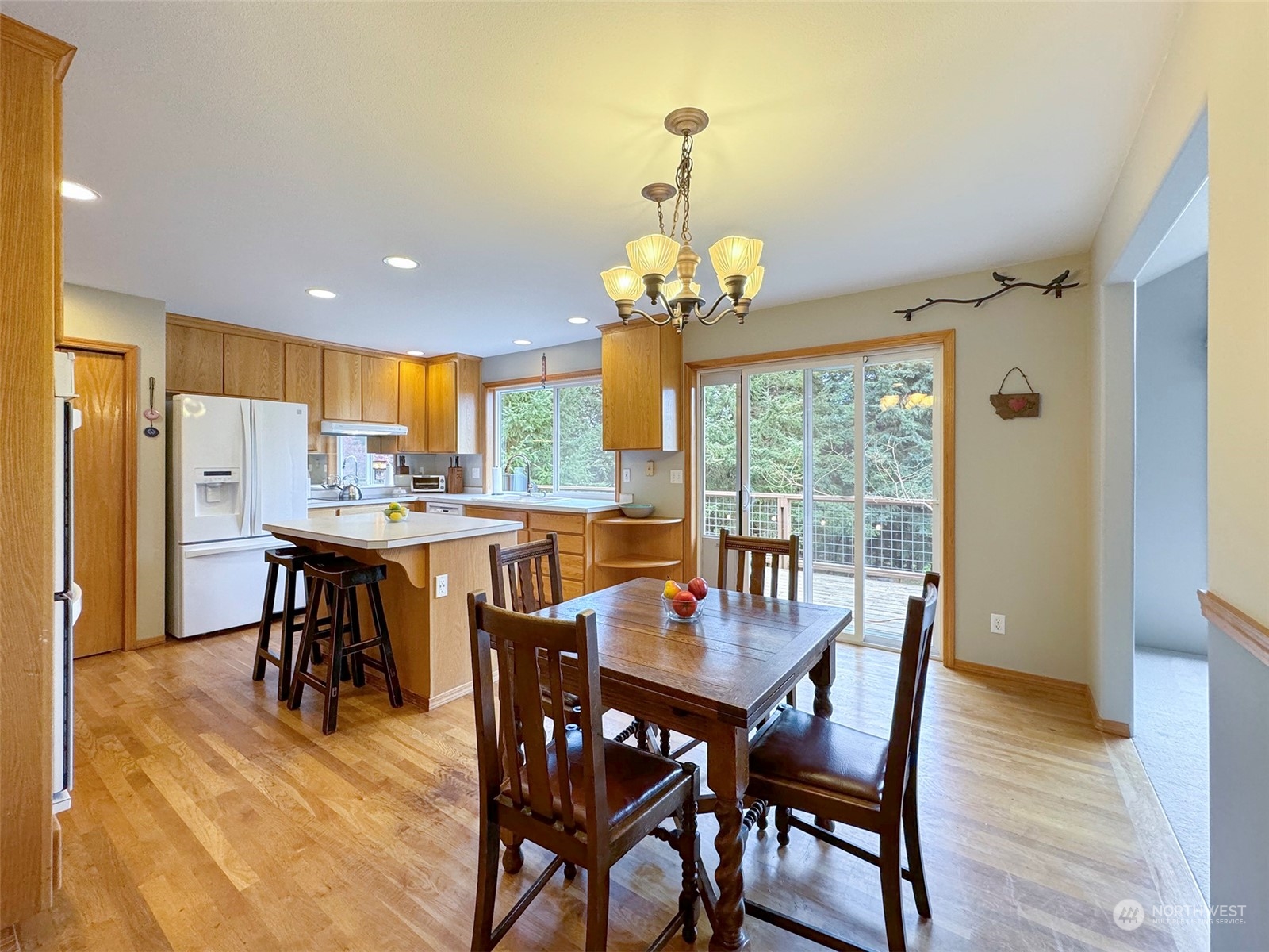 110 Henkes Road Sequim, WA 98382 - Photo 10 of 40 a dining room with furniture a chandelier and wooden floor