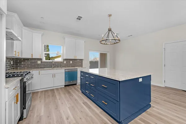a view of walk in closet with wooden floor
