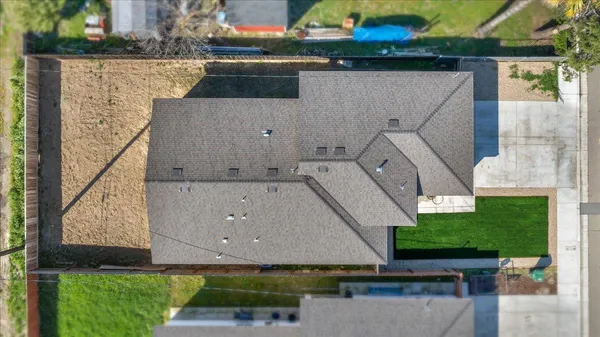 a front view of a house with a garden and yard