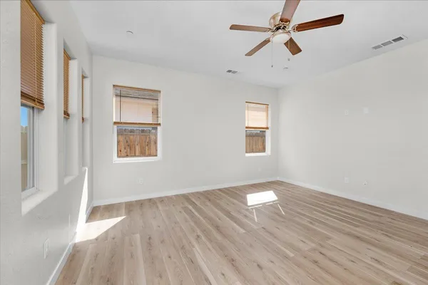 a room with kitchen island and wooden floor