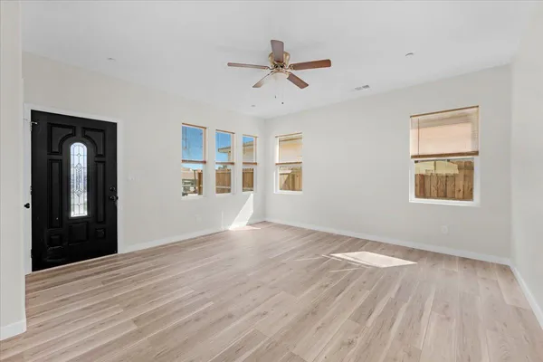 a kitchen with stainless steel appliances granite countertop a stove and a wooden floors