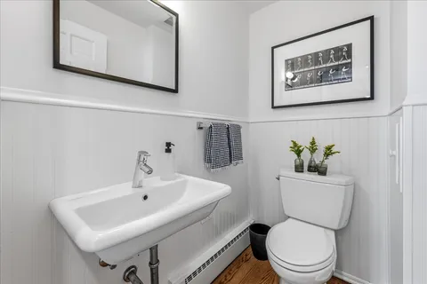 a white toilet sitting next to a bathroom sink