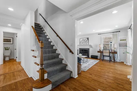 a view of entryway and hall with wooden floor