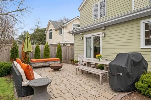 a view of a patio with couple of chairs and a couch