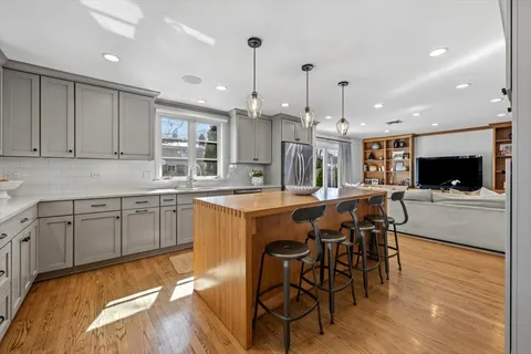 a large kitchen with a table and chairs in it