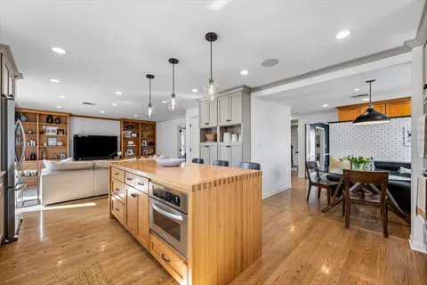 a large kitchen with stainless steel appliances kitchen island a large island in the center