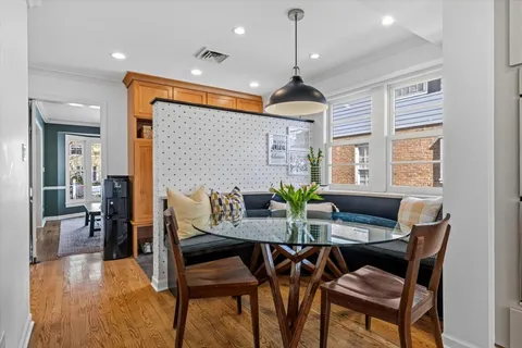 a view of a dining room with furniture window and wooden floor