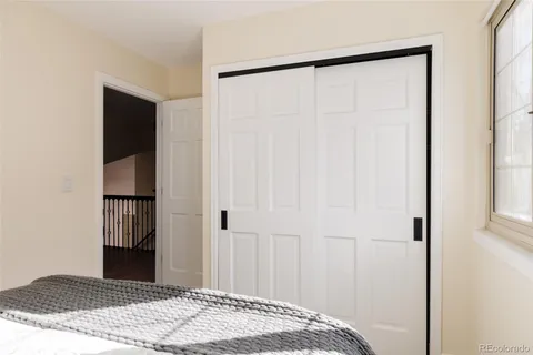 a view of a bedroom with a wooden floor and closet