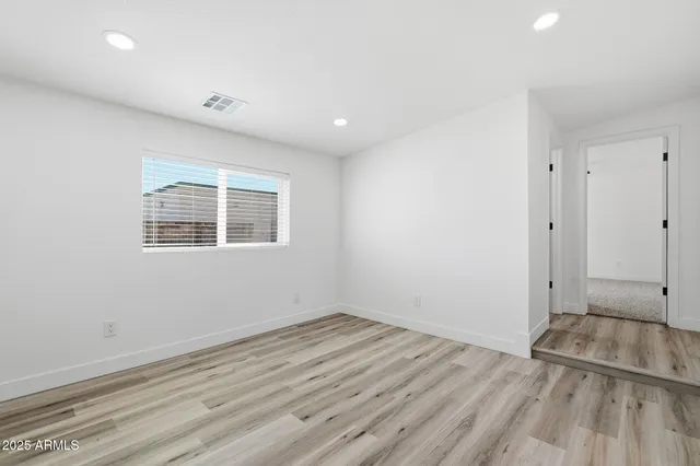 a view of a room with wooden floor and window