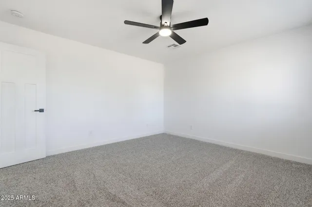 a view of a room with a ceiling fan