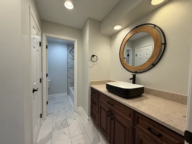 a bathroom with a sink and a mirror