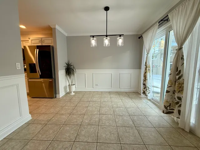 a view of a refrigerator and window in a room