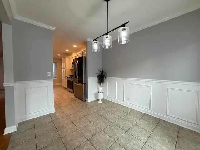 a view of a kitchen with a refrigerator and a sink
