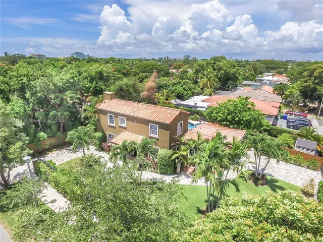 a view of a garden with a building in the background