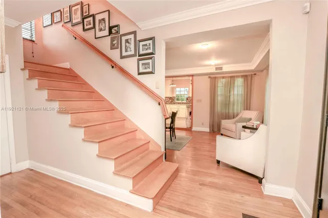 a view of entryway and hall with wooden floor