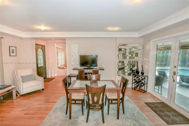 a dining room with furniture and wooden floor