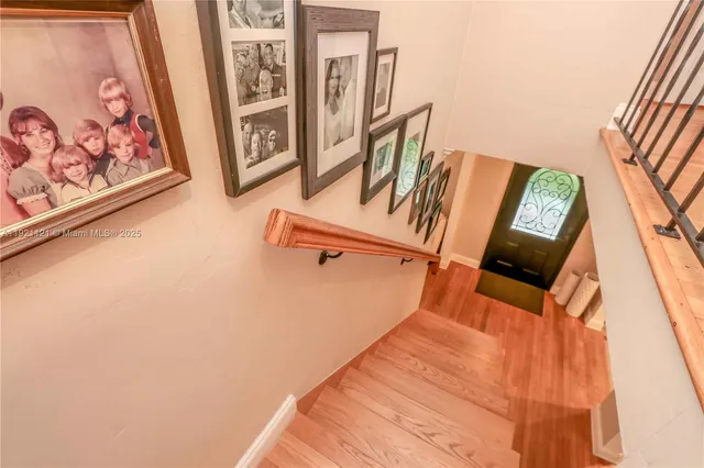 a view of staircase with rug and window