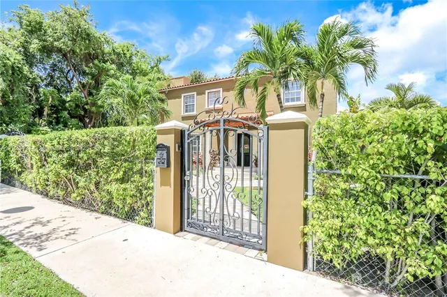 a view of a house with a small yard and plants