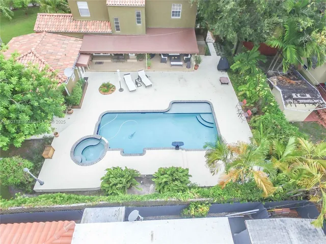 an aerial view of a house with a yard and garden