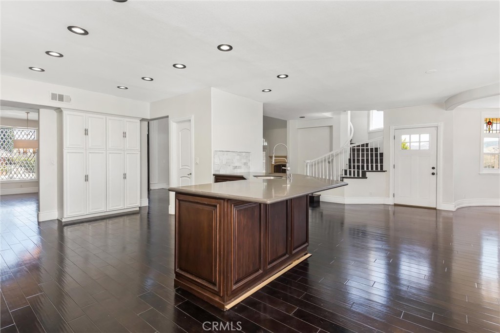1608 Smiley Ridge Redlands, CA 92373 - Photo 32 of 84 a kitchen with stainless steel appliances granite countertop a refrigerator a sink dishwasher and a fireplace with wooden floor