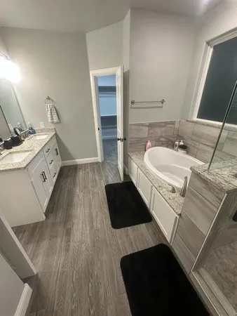 a spacious bathroom with a double vanity sink and a mirror