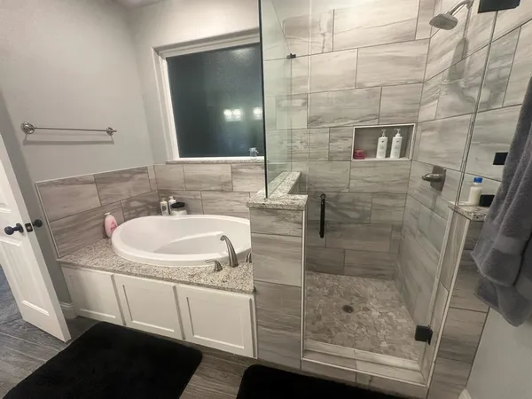 a bathroom with a sink a mirror and shower