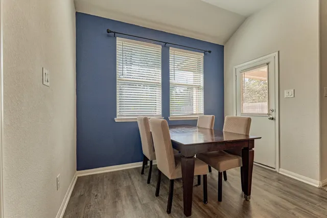 a view of a dining room with furniture and wooden floor