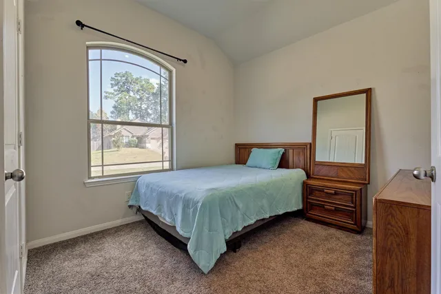 a bedroom with a bed and a dresser