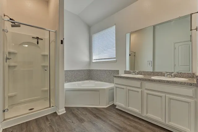 a bathroom with a granite countertop sink a toilet and shower