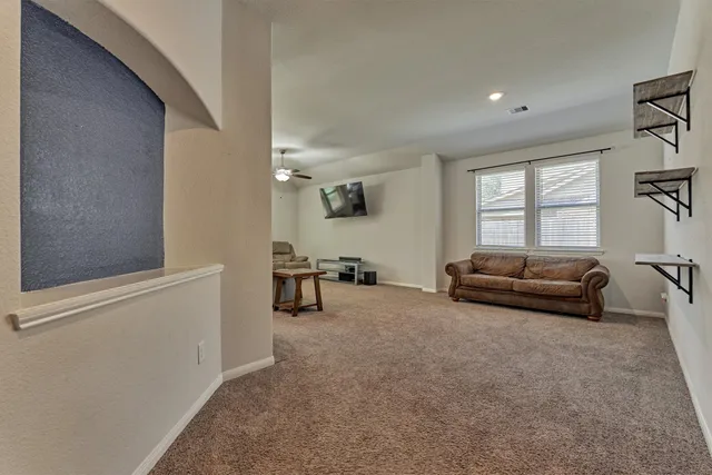 a view of a livingroom with furniture and a window