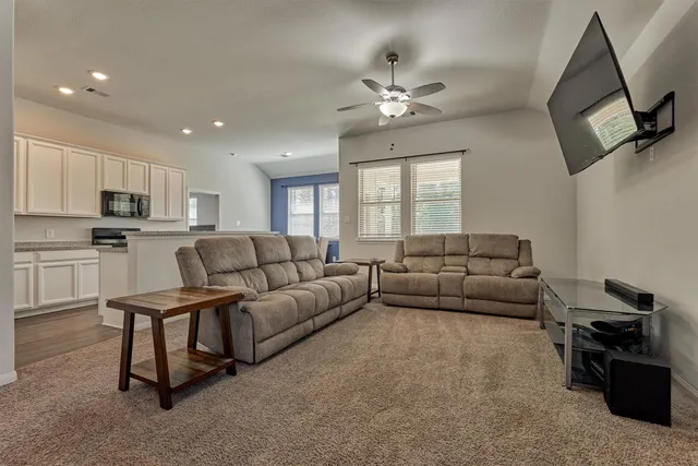 a living room with furniture and a chandelier