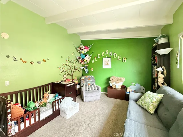 a bedroom with furniture and a large window