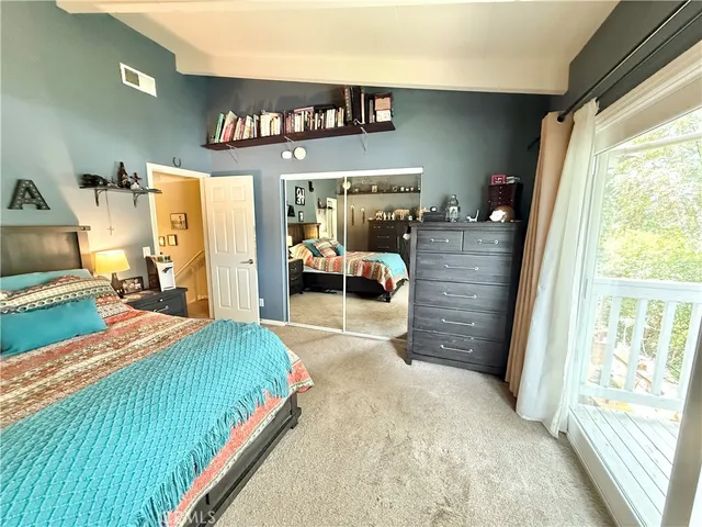 a bedroom with a bed and a large window