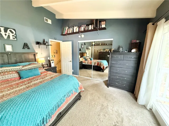 a bedroom with a bed and a couch