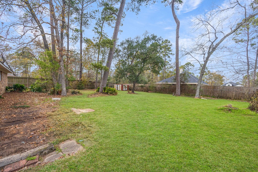 2114 Eagle Point Road Crosby, TX 77532 - Photo 18 of 19 a backyard of a house with lots of green space