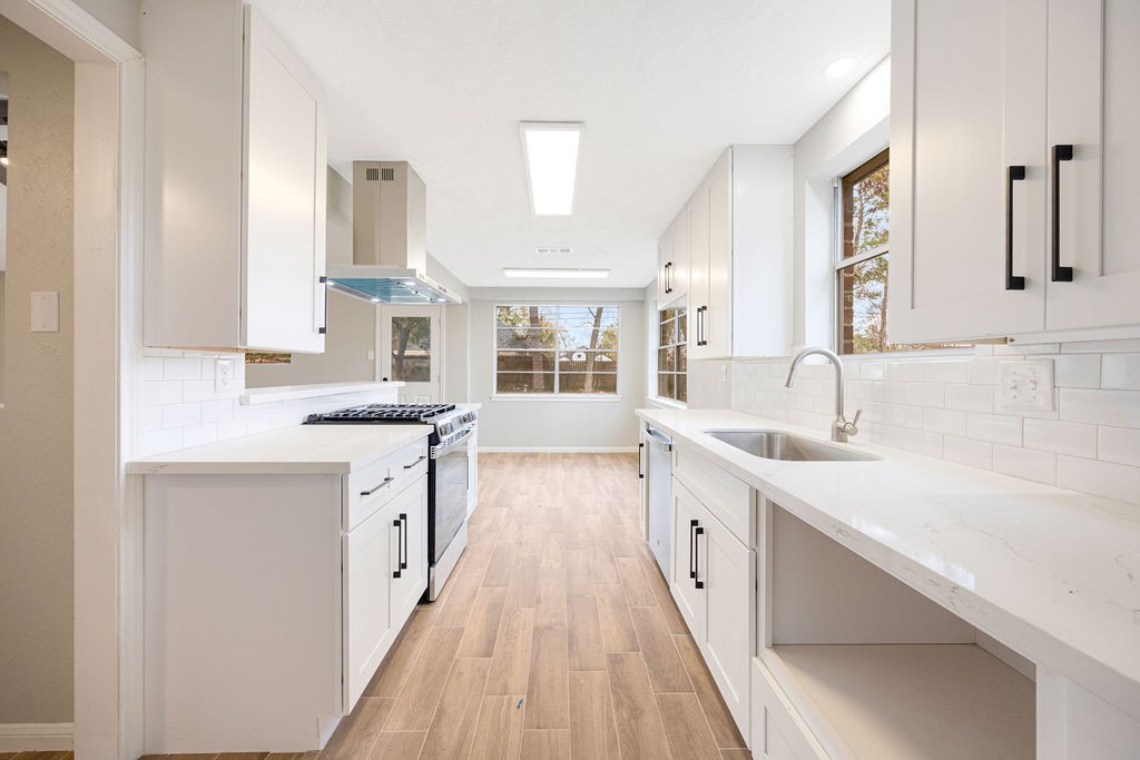 2114 Eagle Point Road Crosby, TX 77532 - Photo 3 of 19 a large kitchen with a lot of counter space and wooden floor
