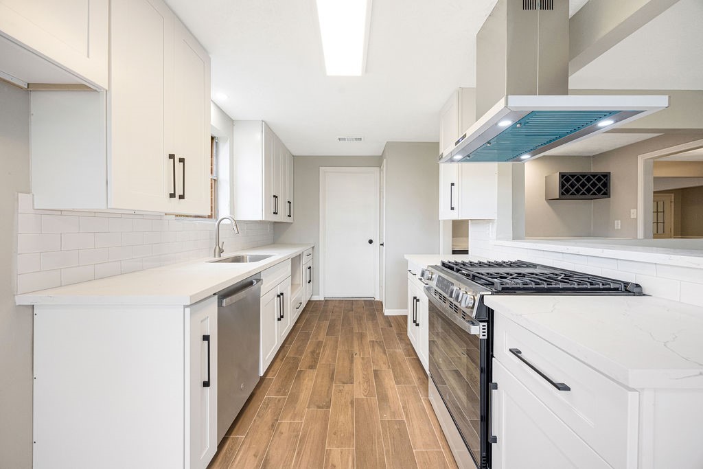 2114 Eagle Point Road Crosby, TX 77532 - Photo 4 of 19 a kitchen with stainless steel appliances granite countertop a stove and a sink