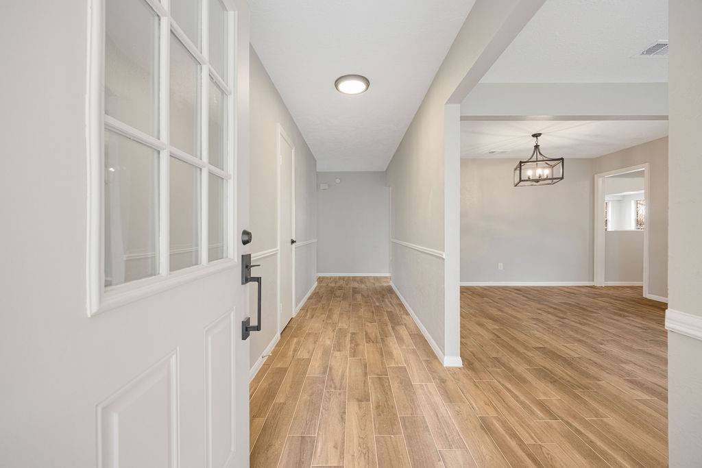 2114 Eagle Point Road Crosby, TX 77532 - Photo 6 of 19 a view of a hallway view with wooden floor and staircase