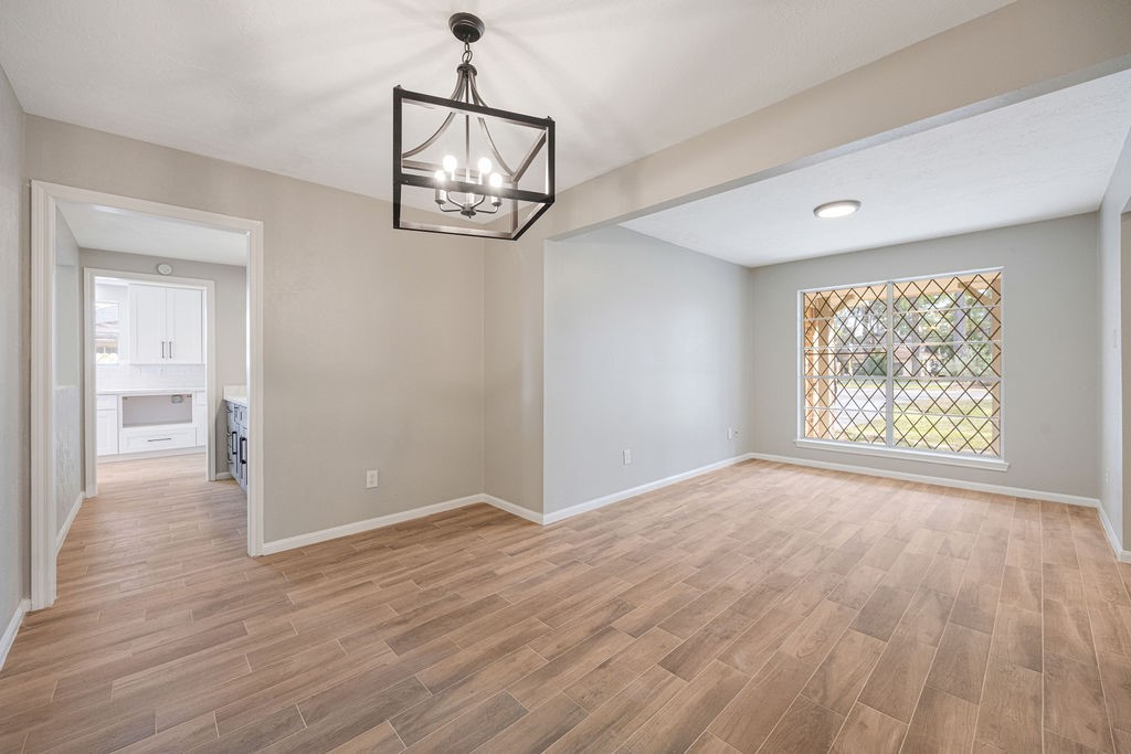 2114 Eagle Point Road Crosby, TX 77532 - Photo 8 of 19 a view of an empty room with wooden floor and a window