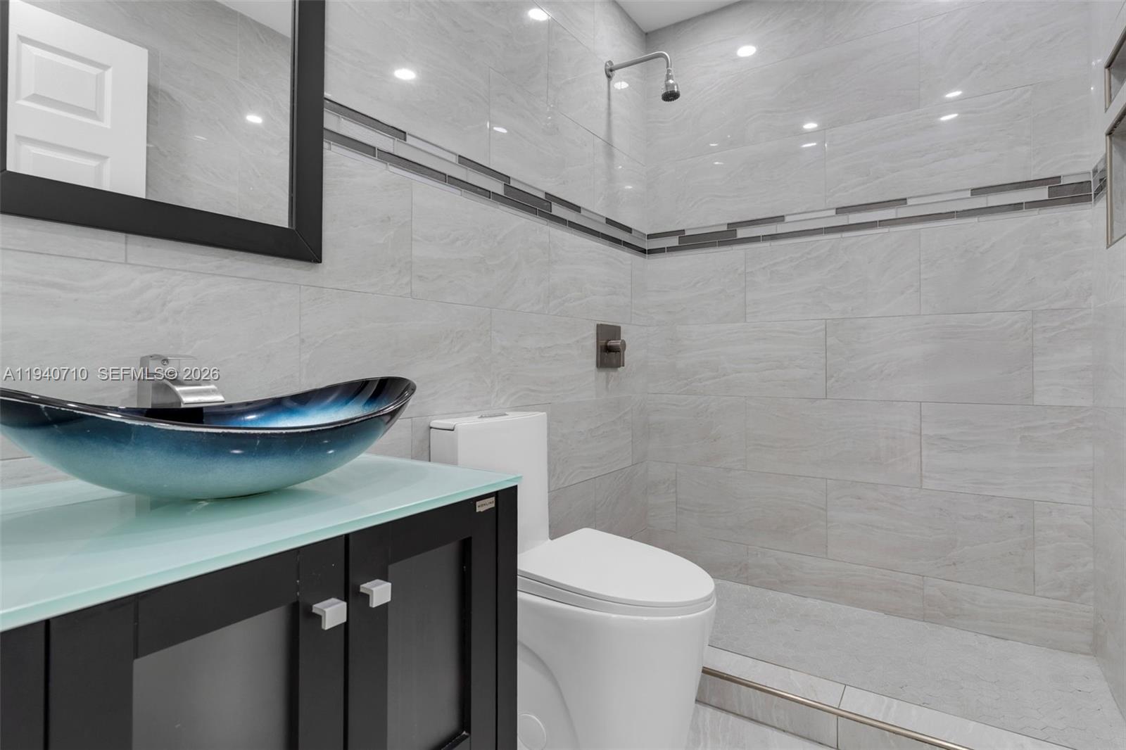 20900 Southwest 118th Avenue Miami, FL 33177 - Photo 16 of 41 a bathroom with a sink a toilet and a shower