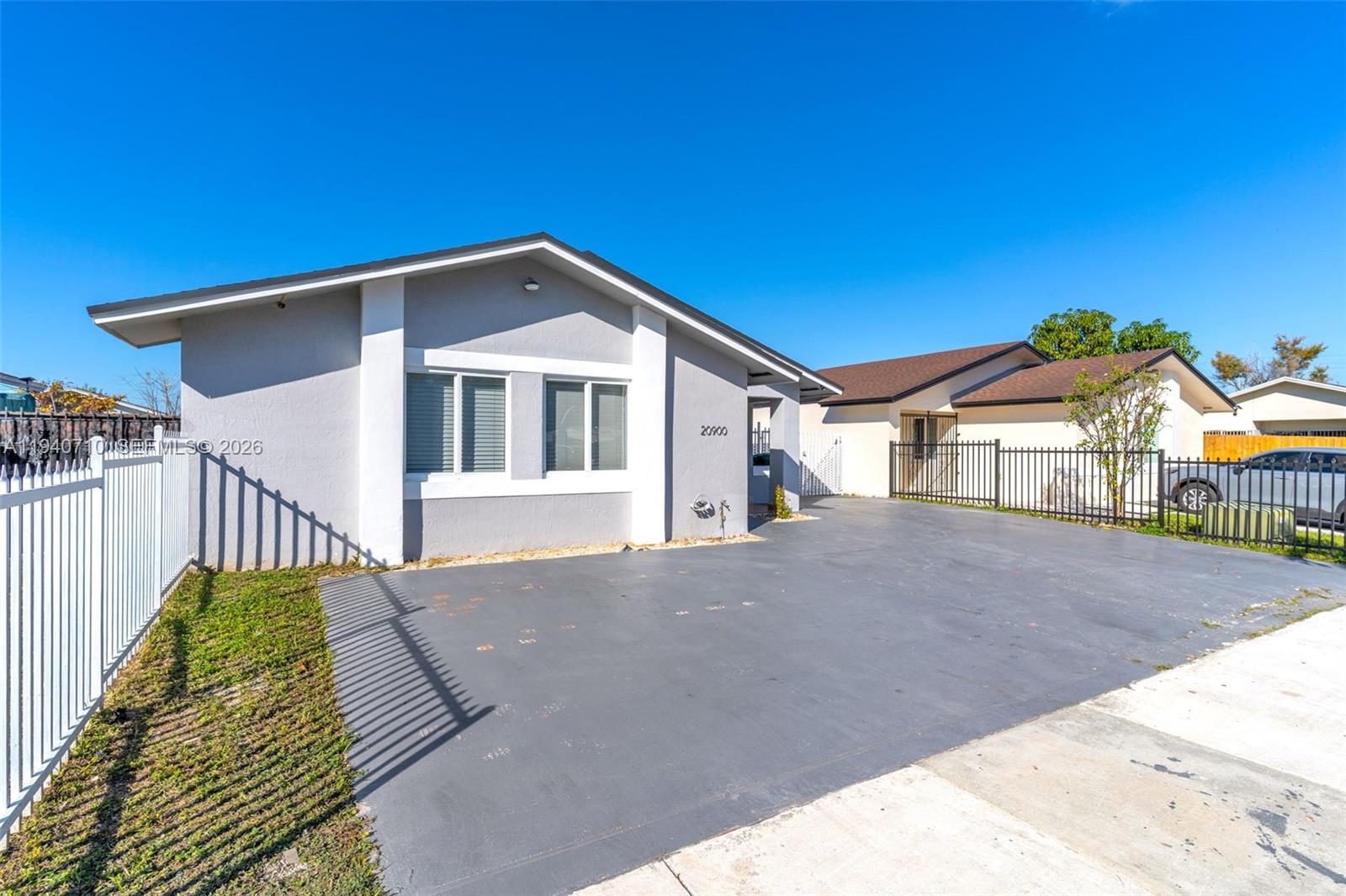 20900 Southwest 118th Avenue Miami, FL 33177 - Photo 2 of 41 a front view of a house with a yard