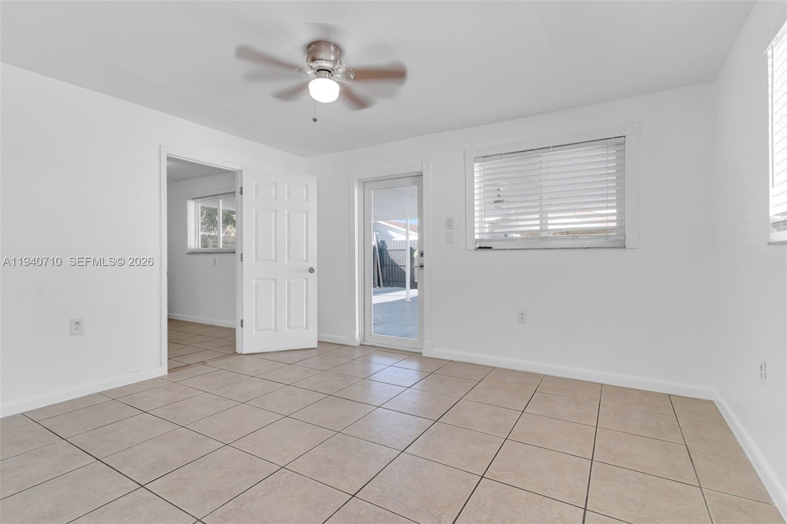 20900 Southwest 118th Avenue Miami, FL 33177 - Photo 22 of 41 a view of an empty room with window and chandelier fan